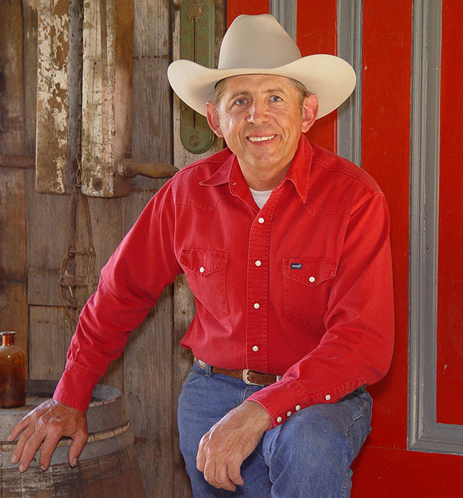 Monte in front of his red door